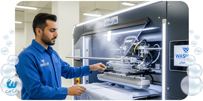 یک کارمند مرد ایرانی با یونیفرم واش‌لین در کارخانه، در حال کار با تجهیزات اتومات خشکشویی و پرس پیشرفته برای اتو کشیدن لباس.